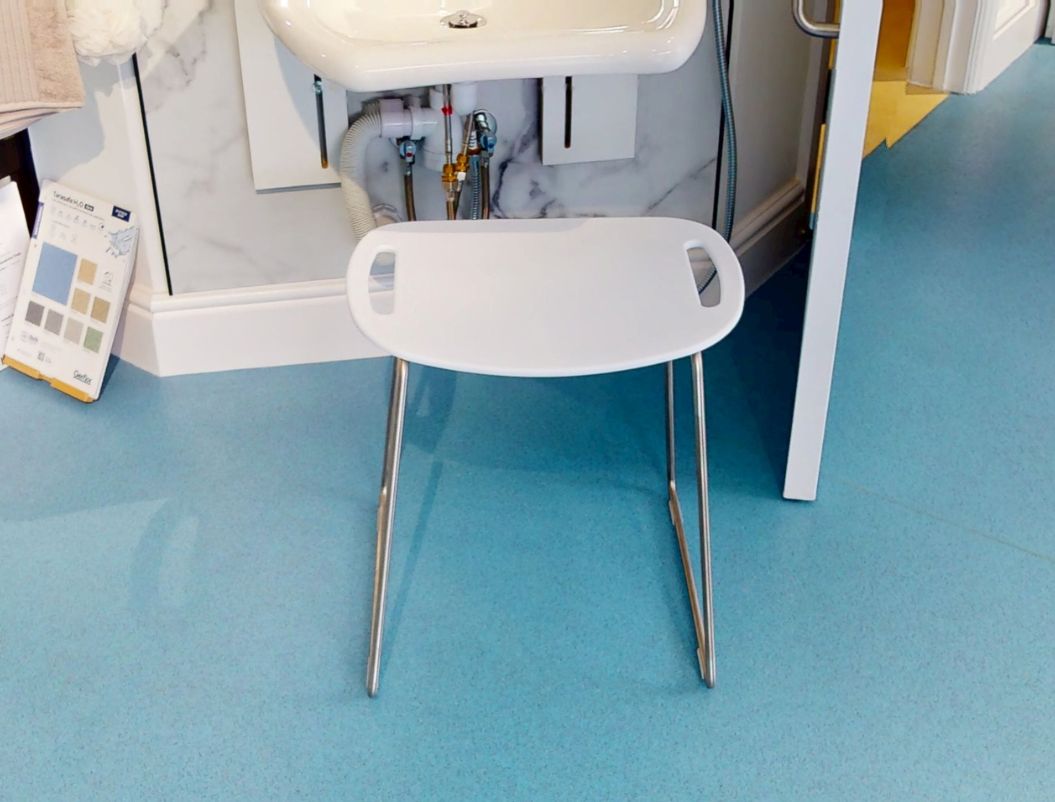 HEWI white shower stool with chrome legs