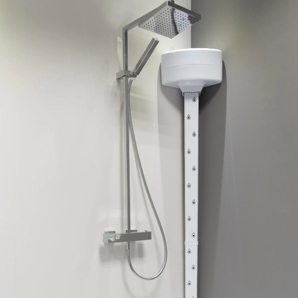 A wall mounted warm air body dryer installed in a shower enclosure